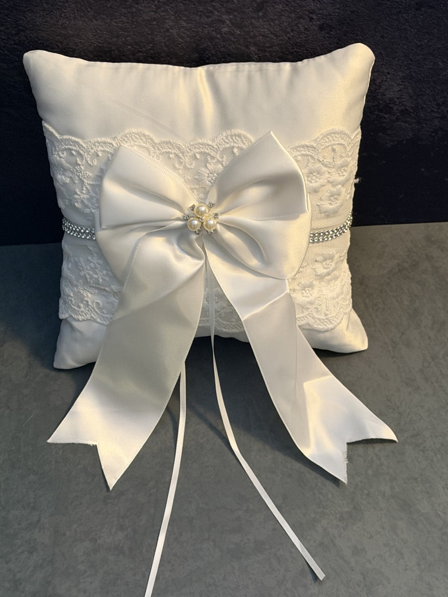 White lace ring bearer pillow with satin bow, rhinestones, and pearls